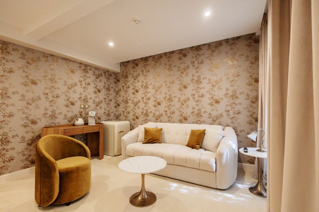 Salon capitonné beige et papier peint bambous dorés, espace indépendant de la Suite Kara — La Villa Kara, proche Valence